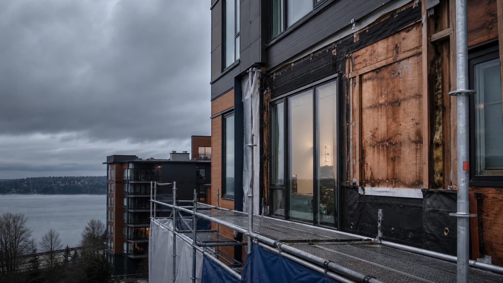 Multifamily building-envelope investigation with cladding removed and scaffolding in place.